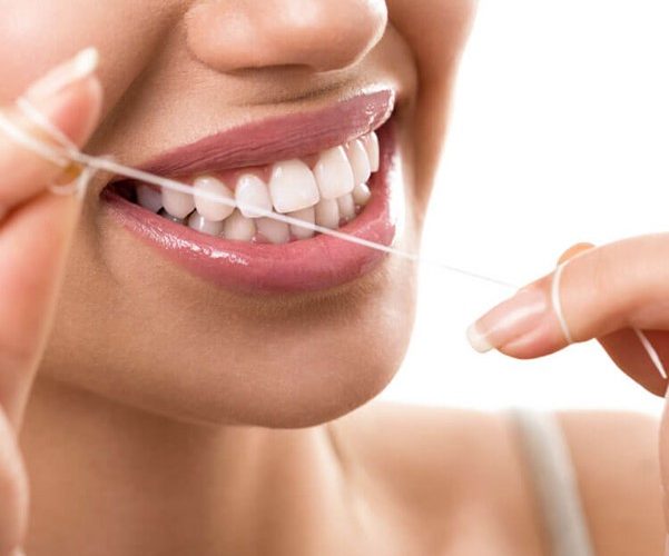 woman flossing teeth